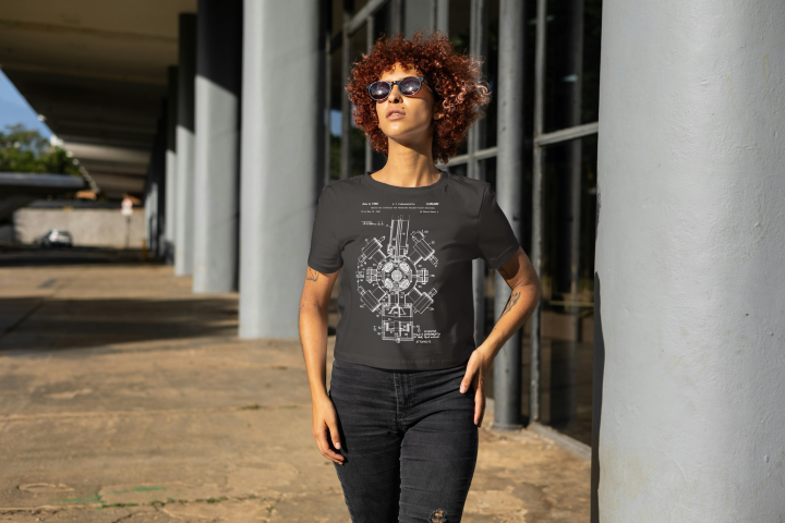 Young female model wearing the new T-shirt design discussed in the blog post. She is standing outside a modern building. 