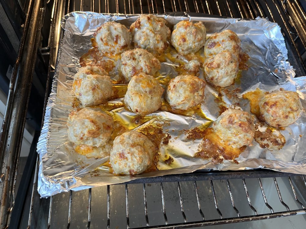 About 12 cooked chicken meatballs. They are paler than pork or beef meatballs.