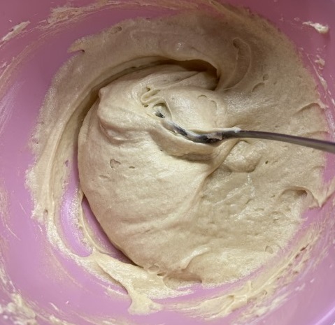 Sponge batter in a pink bowl.